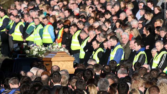 The body of Michaela Harte-McAreavey passes mourners during the funeral 