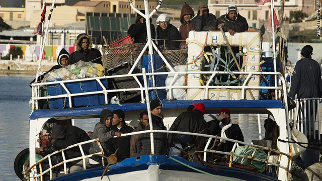A boat carrying Tunisian immigrants arrives at the Italian island of Lampedusa on Sunday.