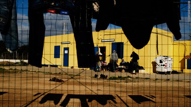 Immigrants who arrived on Lampedusa in the last few days hang their clothes to dry outside their temporary accommodation.