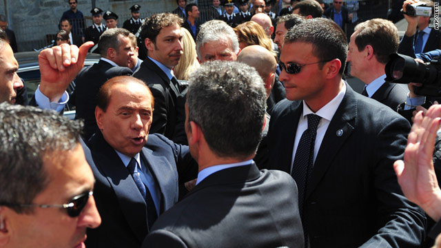 Italian PM Silvio Berlusconi addresses the crowd outside court in Milan on Monday -- he faces financial corruption charges.