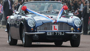 Royal newly-weds swap carriage for Aston Martin