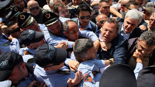 Opposition lawmakers attempt to push through a police line to get to the Central Election Commission in Tirana on Wednesday.