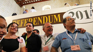 Green Party members announce the 'yes' vote in the poll to legalize divorce in Malta at a polling station in Valetta Sunday.