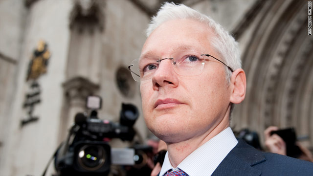 Wikileaks founder Julian Assange pushes through photographers and camera crews leaving the High Court in central London.