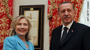 Secretary of State Hillary Clinton stands with Turkish Prime Minister Tayyip Erdogan.