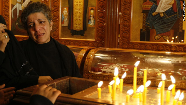 A woman mourns during Sunday Mass at the Church of the Two Saints in Alexandria, Egypt, which was bombed on Saturday.