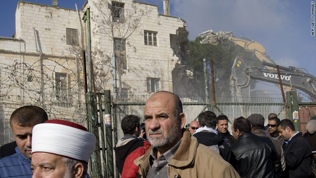 Palestinians protest as Israeli bulldozers demolish a hotel to make way for Jewish settlements in the Sheikh Jarrah neighborhood.