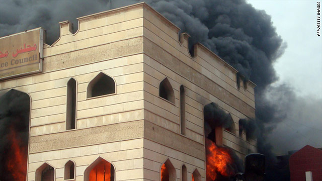 Flames engulf the Wasit council building in Kut, where over 1,000 Iraqis demanded the provincial governor's resignation.