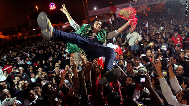Bahraini protesters hoist a released political prisoner in the air at Pearl roundabout, Manama, on February 22, 2011.