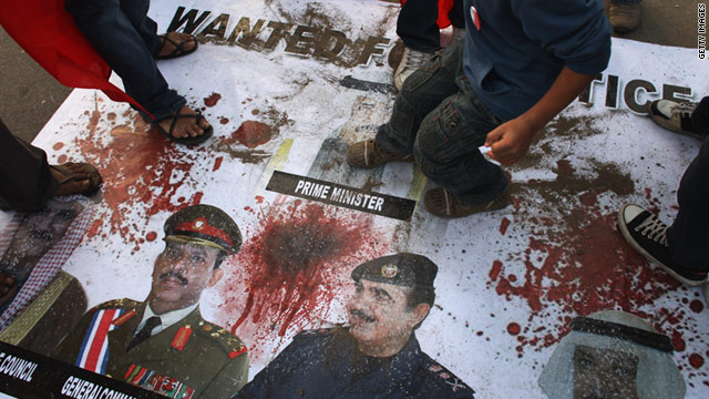 Protesters stomp on a poster of Bahraini government leaders at the Pearl roundabout in Manama on February 21.