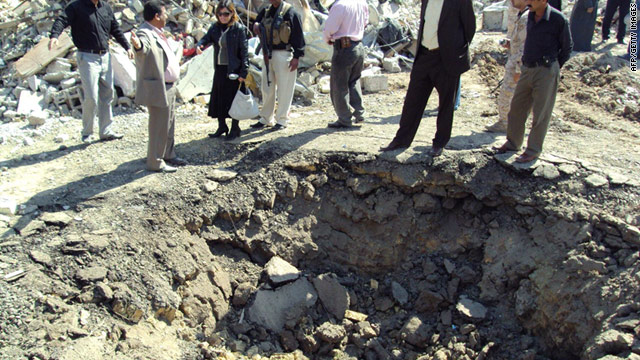 Iraqis inspect the crater left by a truck bomber who ran into a military barracks in Kanan, Diyala province on Monday.