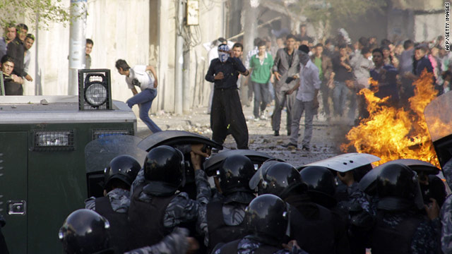 Iraqi riot police lift their shields as thousands rally in the city of Sulaymaniyah on Friday, April 1.