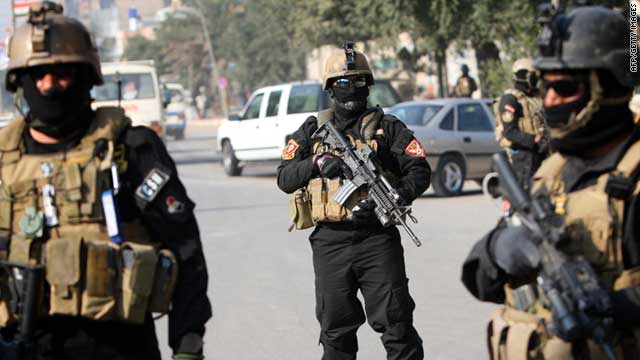 Members of an Iraqi anti-terror unit stand guard at a checkpoint in Baghdad in January.