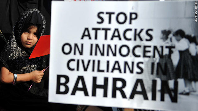 An Indian child stands next to a placard during a protest against the political turmoil in Bahrain in Mumbai on March 25, 2011.