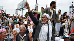 Yemeni anti-government protesters shout slogans during an anti-regime demonstration on April 22.