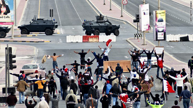 Anti-government protestors in front of military vehicles near Pearl Square in Bahraini capital Manama on March 16.