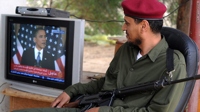 A rebel fighter watches U.S. President Barack Obama's speech on TV in the eastern Libyan town of Zuwaytinah.