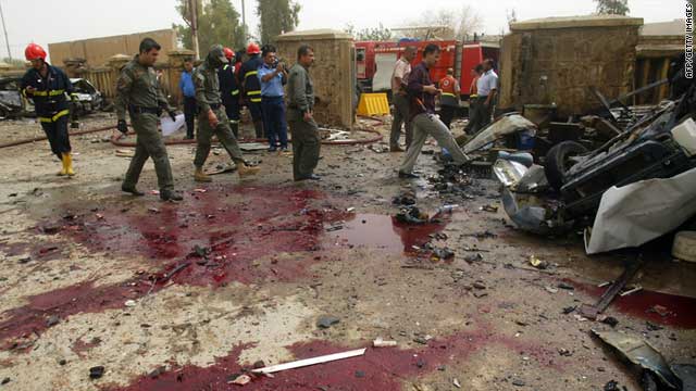 Iraqi police inspect the site of a bomb attack in the northern city of Kirkuk on May 19, 2011.