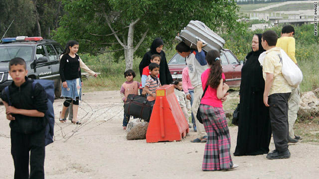 Syrians flee on foot on April 28, 2011 into Wadi Khaled in Lebanon after unrest broke out in the Syrian town of Tall Kalakh.