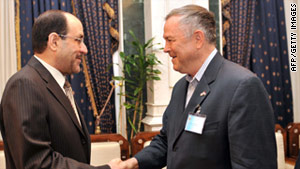 Iraqi Prime Minister Nuri al-Maliki, left, and Rep. Dana Rohrabacher shake hands in Baghdad on Friday.