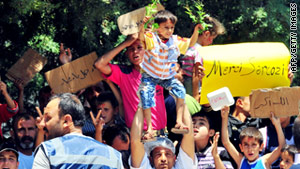 Syrian refugees chant slogans during a demonstration at a Turkish Red Crescent camp near the Syrian border.