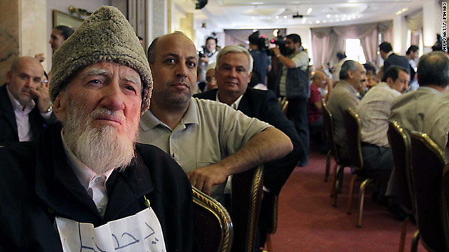 Muslim cleric Jodat Said, left, sits in on a public conference on democratic reform in Syria on Monday.