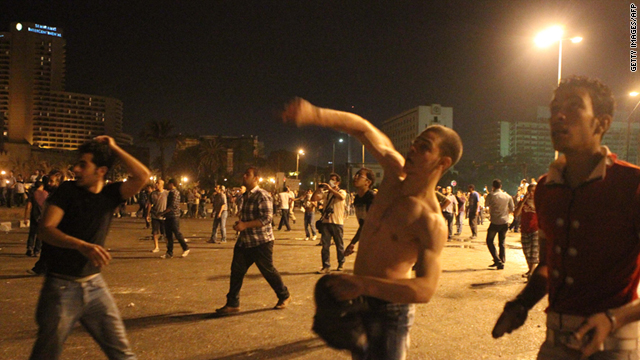 Protesters throw stones at riot police during clashes in Tahrir Square in Cairo, Egypt, during the early hours of June 29.