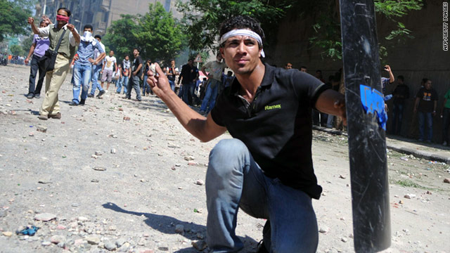 Egyptian protesters throw stones at anti-riot police during clashes in Cairo's Tahrir Square on June 29.