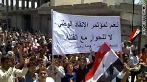 Syrian anti-government protesters march during a demonstration in the town of Kafr Nabel on Friday.