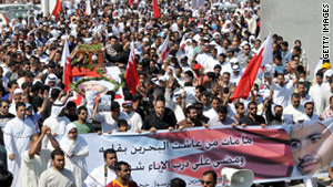 Bahraini Shiite Muslims with the coffin of Abdulrassul Hujairi, who went missing in the crackdown,  near Manama on March 21, 2011.