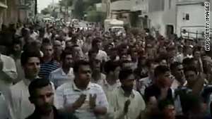 An image taken from footage uploaded on YouTube shows Syrian anti-government protesters marching in Hama Friday.