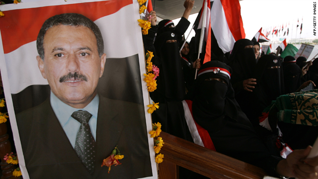 Yemeni men and children hold up portraits of President Ali Abdullah Saleh during a pro-regime rally in Sanaa on July 1.