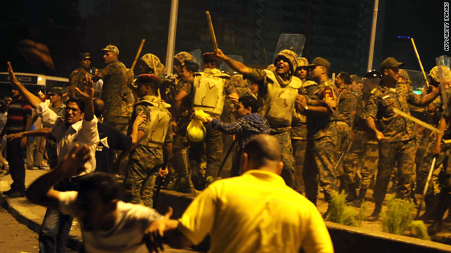 Egyptian military police react as some demonstrators throw stones and water bottles during a protest at Cairo's Tahrir Square on August 12.