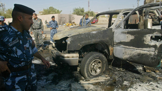 Iraqi security forces inspect a site after an explosion in the northern city of Kirkuk after a series of bomb attacks across Iraq.