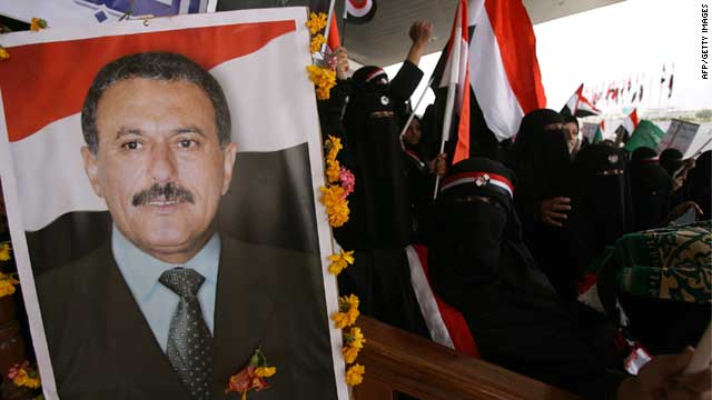 Yemeni men and children hold up portraits of President Ali Abdullah Saleh during a pro-regime rally in Sanaa on July 1, 2011.