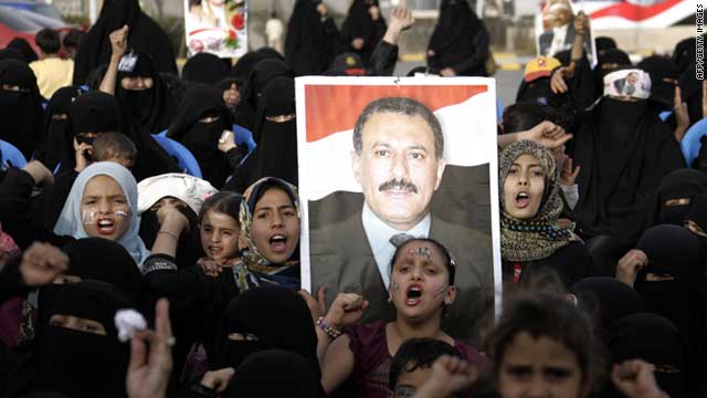 Yemeni women and children hold a portrait of President Ali Abdullah Saleh during a rally in Sanaa on July 17, 2011.