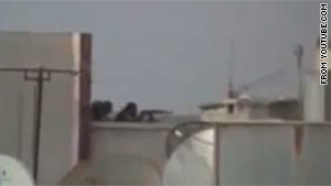 A video posted to YouTube.com purports to show snipers on a roof in Homs, Syria.