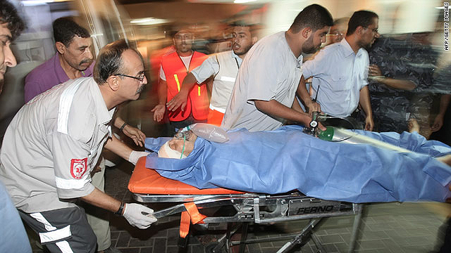 A wounded Palestinian man receives medical care at a hospital in Gaza following strikes by Israeli warplanes.  