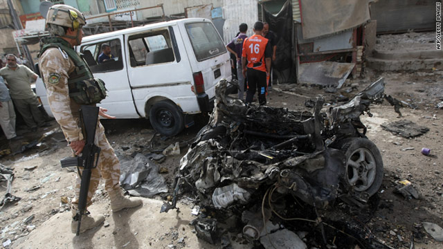 An Iraqi soldier inspects the scene of a bomb blast in the north Baghdad district of Sadr City on May 22, 2011.