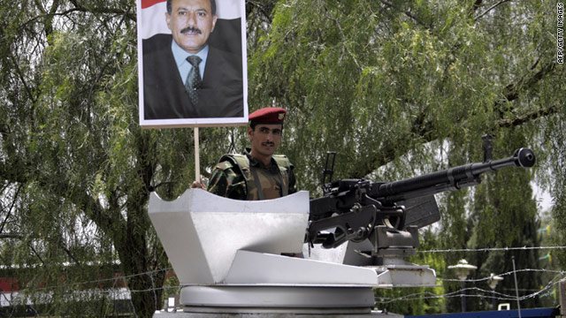 A Yemeni soldier holds up a picture of President Ali Abdullah Saleh during a rally in support of his regime on September 2, 2011.