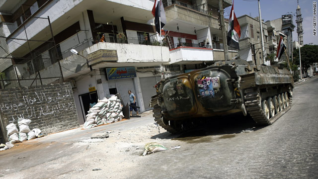 A Syrian military tank takes up a position in a residential street in the flashpoint city of Homs on August 30, 2011.