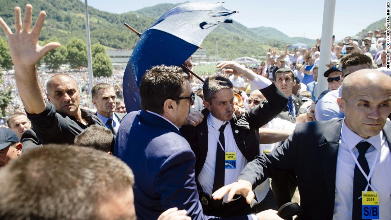 Crowd throws rocks as Aleksandar Vucic leaves commemoration