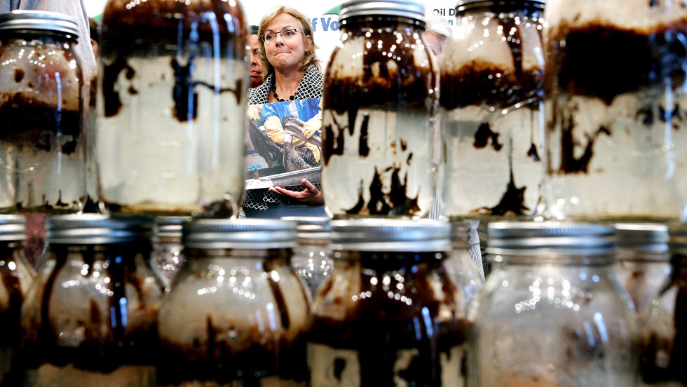 Mary Wilkerson, owner of Gulfside Resorts in Indian Rocks Beach, Florida, attends a Capitol Hill news conference on Wednesday, June 16, in Washington.  The jars in front of her hold water mixed with oil that was collected from the Gulf Coast waters of Louisiana and Alabama. - CNN