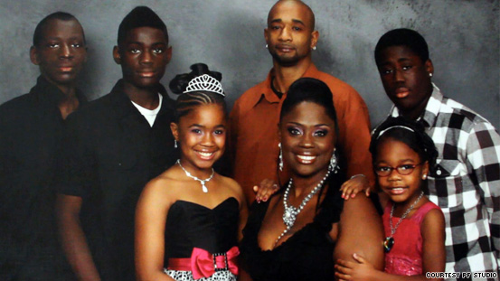 Charles Daniel, far left, poses with his family for a portrait.
