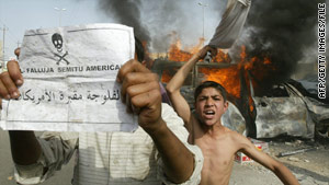 Iraqis taunt U.S. forces with a leaflet reading, "Falluja:  Cemetery for Americans" in March 2004.