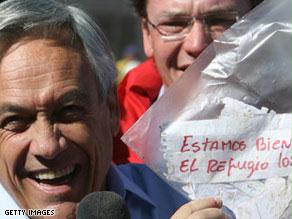 الرئيس التشيلي يحمل الورقة التي كتبها عمال المنجم العالقين على عمق 2300 قدم