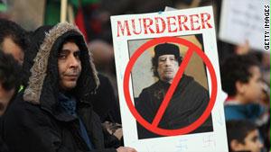 متظاهرون يرفعون صوراً تندد بالقذافي
