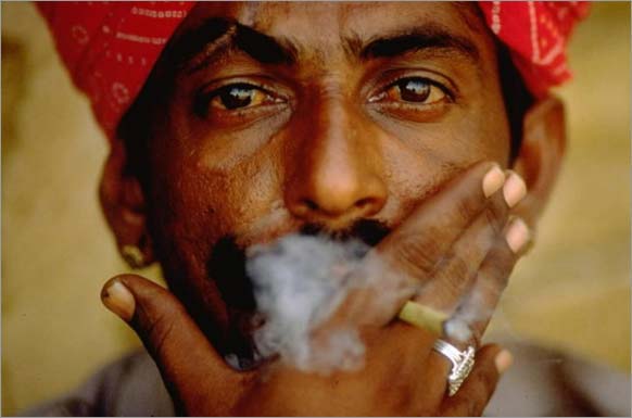 Man smoking a bidi, a hand-rolled Indian cigarette, 1997, Dilip Mehta